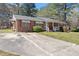 Property featuring a brick exterior, a long driveway, and manicured landscaping at 5630 Jones Sausage Rd, Garner, NC 27529