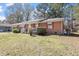 Quaint brick home with a front porch and lush green lawn at 5630 Jones Sausage Rd, Garner, NC 27529
