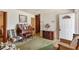 Living room with patterned chair, vintage carpet, and furniture at 5630 Jones Sausage Rd, Garner, NC 27529