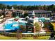 Experience luxury with this bird's-eye view of the community pool and clubhouse surrounded by lush landscaping at 603 Mountain Pine Dr, Cary, NC 27519