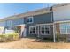 View of townhome backyard with a small brick patio at 603 Mountain Pine Dr, Cary, NC 27519