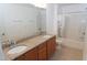 Bathroom showcasing double sink vanity with granite countertop, tub-shower and tile flooring at 603 Mountain Pine Dr, Cary, NC 27519