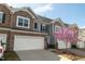 Townhome exterior with a two-car garage and beautiful blooming tree at 603 Mountain Pine Dr, Cary, NC 27519
