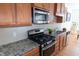 Close-up of stainless steel kitchen appliances and granite counters at 603 Mountain Pine Dr, Cary, NC 27519