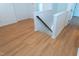White staircase with wood-look flooring landing, and white trim at 603 Mountain Pine Dr, Cary, NC 27519