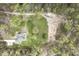 An aerial view of a house with lush greenery surrounding it, set in a peaceful location at 610 Flemingtown Rd, Henderson, NC 27537