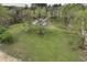 Expansive property with lush green lawn, mature trees, and a charming ranch-style home with patio, serene setting at 610 Flemingtown Rd, Henderson, NC 27537