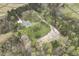 Birds eye view of a home with long driveway and tree lined property at 610 Flemingtown Rd, Henderson, NC 27537