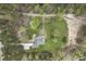 Overhead view of a quaint home featuring lush greenery and an expansive yard at 610 Flemingtown Rd, Henderson, NC 27537