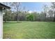 Spacious backyard with lush green grass and mature trees, perfect for outdoor activities at 610 Flemingtown Rd, Henderson, NC 27537