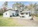 An expansive backyard with patio seating, lush green lawn, and mature trees at 610 Flemingtown Rd, Henderson, NC 27537