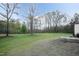 Expansive backyard with mature trees and a patio area, ideal for entertaining at 610 Flemingtown Rd, Henderson, NC 27537