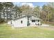 Expansive backyard with patio seating, lush lawn, and mature trees at 610 Flemingtown Rd, Henderson, NC 27537