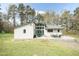 Large backyard with covered patio area, mature trees, and lush green lawn at 610 Flemingtown Rd, Henderson, NC 27537