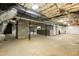 Unfinished basement showing concrete floor, support beams, insulated ceiling and block wall accents at 610 Flemingtown Rd, Henderson, NC 27537