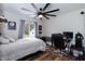 Bedroom featuring a large ceiling fan, wood floors, and a large window at 610 Flemingtown Rd, Henderson, NC 27537