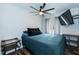 Comfortable bedroom with a ceiling fan, wood floors, and a cozy bed at 610 Flemingtown Rd, Henderson, NC 27537