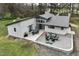 Aerial view of charming home with patio, outdoor dining and fireplace for entertaining at 610 Flemingtown Rd, Henderson, NC 27537