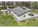 Charming ranch style home on a spacious lot, featuring a gravel driveway and outdoor seating area at 610 Flemingtown Rd, Henderson, NC 27537