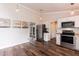 Kitchen offers stainless steel appliances, white cabinets, and dark wood flooring at 610 Flemingtown Rd, Henderson, NC 27537