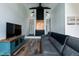 Spacious living room boasts a brick fireplace, modern furniture, and wood floors at 610 Flemingtown Rd, Henderson, NC 27537