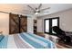 Bedroom featuring a large ceiling fan, wood floors and access to the backyard at 610 Flemingtown Rd, Henderson, NC 27537