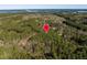 Majestic aerial shot displaying the property's boundary with surrounding lake and natural foliage at 63 Pennington Cir, Chapel Hill, NC 27517