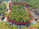 Aerial of the land lot boundaries showcasing expansive acreage amid mature trees and surrounding roads at 63 Pennington Cir, Chapel Hill, NC 27517