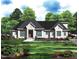 Charming brick home featuring a dark roof, a well-manicured lawn, and professional landscaping at 63 Pennington Cir, Chapel Hill, NC 27517