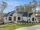Beautiful single-story home boasts a dark roof, a white exterior, and a green, landscaped yard at 63 Pennington Cir, Chapel Hill, NC 27517