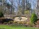 Beautiful stone community sign for Windfall amid manicured landscaping and lush greenery at 63 Pennington Cir, Chapel Hill, NC 27517