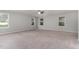 Large carpeted bedroom with a ceiling fan and lots of natural light through windows at 709 Conifer Ct, Creedmoor, NC 27522