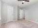 Bright bedroom includes a ceiling fan and a view into the hallway at 709 Conifer Ct, Creedmoor, NC 27522