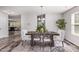 Bright dining room with dark wood table, stylish seating, modern chandelier and decorative rug at 709 Conifer Ct, Creedmoor, NC 27522
