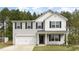 Charming two-story home features a two-car garage and classic black shutters set against a backdrop of lush, mature trees at 709 Conifer Ct, Creedmoor, NC 27522