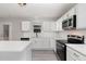 Modern kitchen featuring white cabinets, stainless steel appliances, quartz countertops, and an island perfect for entertaining at 709 Conifer Ct, Creedmoor, NC 27522