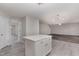 Modern kitchen featuring white cabinets, stainless steel appliances, quartz countertops, and an island perfect for entertaining at 709 Conifer Ct, Creedmoor, NC 27522