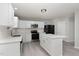 Modern kitchen featuring white cabinets, stainless steel appliances, quartz countertops, and an island perfect for entertaining at 709 Conifer Ct, Creedmoor, NC 27522