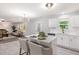 Modern kitchen with island, white cabinets, and open layout to the living area at 709 Conifer Ct, Creedmoor, NC 27522