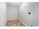 Practical laundry room featuring tile flooring and shelving at 709 Conifer Ct, Creedmoor, NC 27522