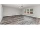 Bright room with wood-look floors and ample windows at 709 Conifer Ct, Creedmoor, NC 27522