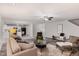 Open concept living room featuring neutral color scheme, ceiling fan, and wood-look flooring at 709 Conifer Ct, Creedmoor, NC 27522