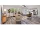 Bright living room with wood-look floors, plush sofa, and plenty of natural light at 709 Conifer Ct, Creedmoor, NC 27522