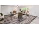 Cozy living room showcasing wood-look floors, comfortable seating, and large windows at 709 Conifer Ct, Creedmoor, NC 27522