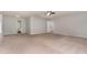 Spacious main bedroom featuring neutral carpet, a ceiling fan, and multiple doorways at 709 Conifer Ct, Creedmoor, NC 27522