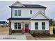 Charming two-story home featuring a striking red front door and a well-manicured lawn at 73 Legolas Ct, Middlesex, NC 27557