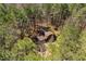 A high-angle shot captures the home surrounded by lush greenery at 735 Jordan Hills Loop, Chapel Hill, NC 27517