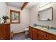 Bathroom featuring a vanity, toilet, and window with wooded view at 735 Jordan Hills Loop, Chapel Hill, NC 27517
