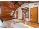 Bedroom featuring hardwood floors, wood ceilings and multiple doors at 735 Jordan Hills Loop, Chapel Hill, NC 27517