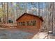 Exterior view of a rustic home with a wooded surrounding at 735 Jordan Hills Loop, Chapel Hill, NC 27517